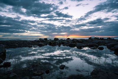 Scenic view of frozen landscape against sky during sunset