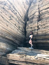 Portrait of young woman on rock