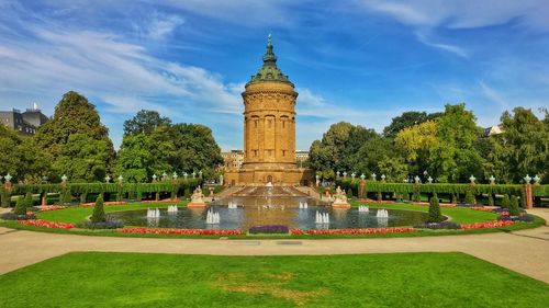 Fountain in garden with building in background