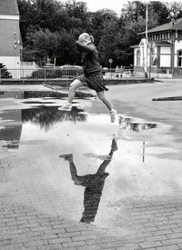 Full length of man jumping in city