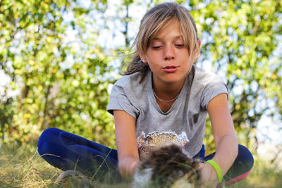 Portrait of young woman sitting on field