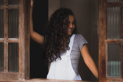 Beautiful young woman standing at home