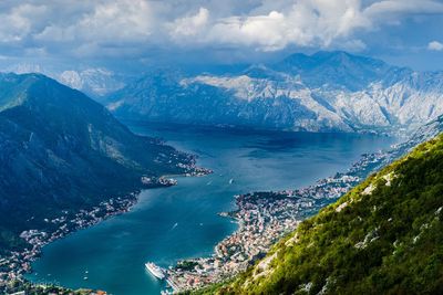 High angle view of sea and mountains against sky