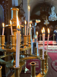 Close-up of illuminated candles on table