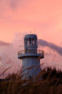 Lighthouse against sky during sunset