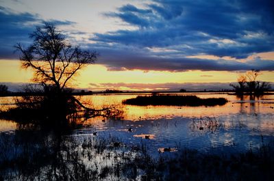 Scenic view of lake against sky during sunset