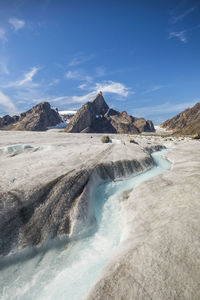 River meanders through a glacier below mount loki, baffin island.