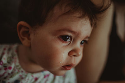 Close-up portrait of cute baby girl at home