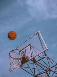 Low angle view of basketball hoop against blue sky