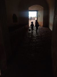 Silhouette people standing in building