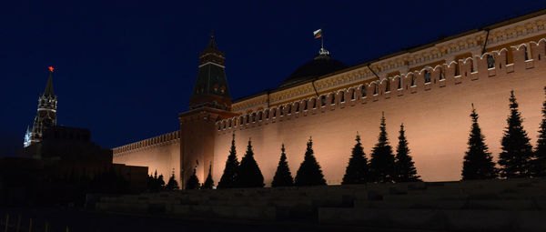 Low angle view of illuminated building against sky at night