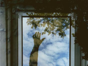 Reflection of hand on glass window