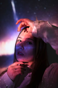 Close-up portrait of young woman smoking