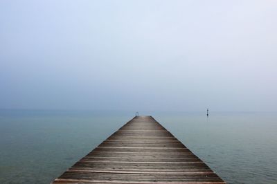 Pier over sea against sky