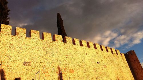 Low angle view of built structure against cloudy sky