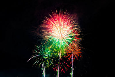 Low angle view of firework display at night