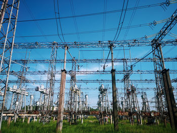 Low angle view of electricity pylon against sky