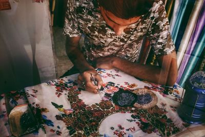 High angle view of woman hand on table