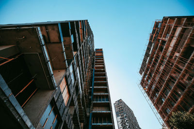 Low angle view of destroyed buildings against clear sky