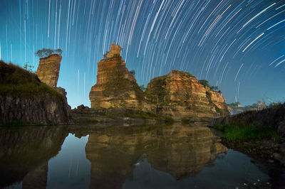 Reflection of rock formations in water at night