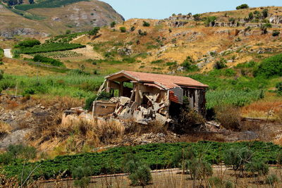 View of cottage of abandoned built structure in field