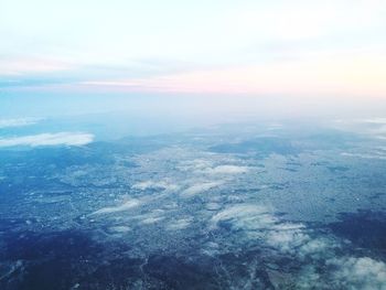 Aerial view of sea against sky during sunset