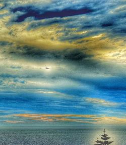 Scenic view of sea against cloudy sky