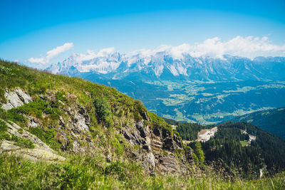 Scenic view of mountains against blue sky