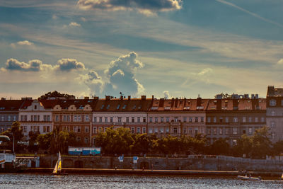 Buildings against cloudy sky