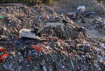 Landfill with construction and demolition waste .  excavator working on industrial landfill. 