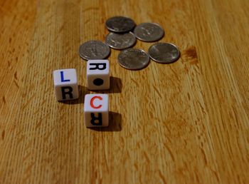 Close-up of dices and coins on table