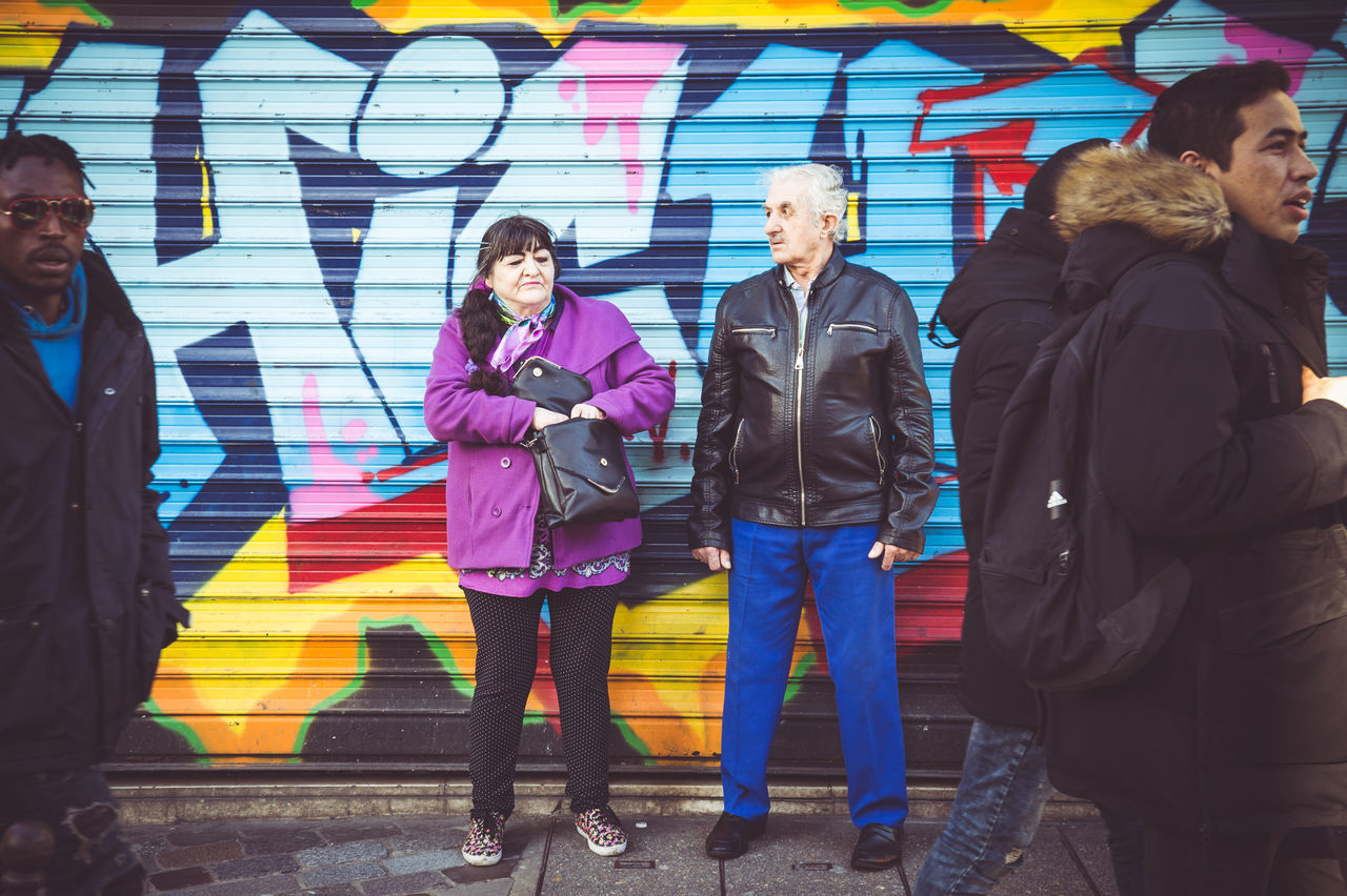 FULL LENGTH OF PEOPLE STANDING AGAINST WALL