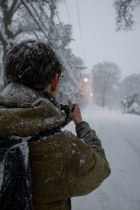 Rear view of man standing in snow