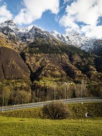 Scenic view of lake by mountains against sky