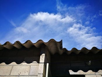 High section of built structures against blue sky