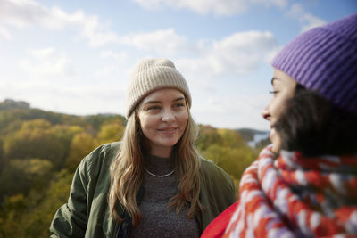 Smiling female friends talking together