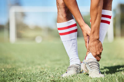 Low section of man playing soccer