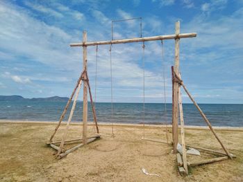 Lifeguard hut on beach against sky