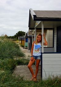 Portrait of girl by beach hut