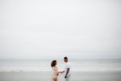 Mixed race couple posing on beach