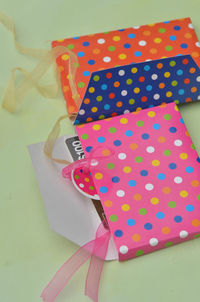 Close-up of colorful paper bags on table