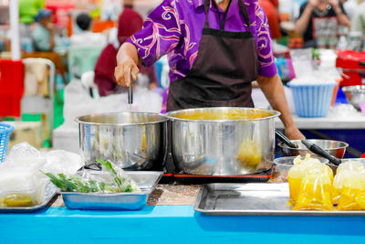 Midsection of man preparing food