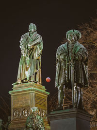 Low angle view of statue at night