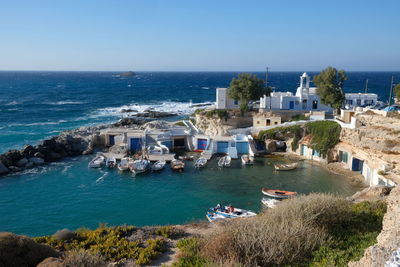 High angle view of sea and buildings against clear sky