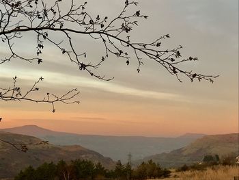 Scenic view of landscape against sky at sunset