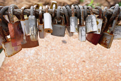 Close-up of abandoned padlocks on railing