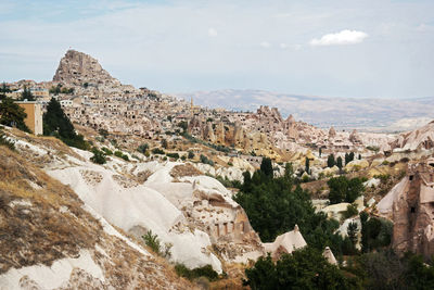 Panoramic view of buildings and mountain against sky