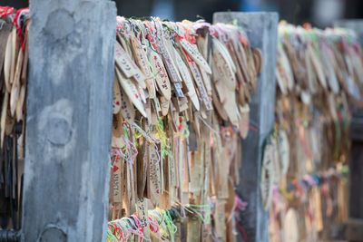 Close-up of labels tied to railing