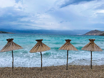Umbrellas on beach against sky