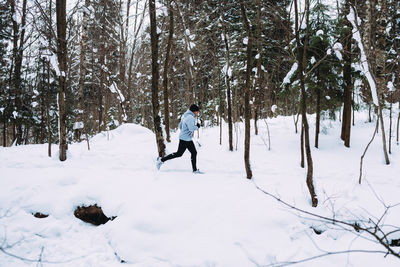 Man running on snow covered field